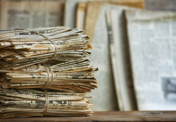 Waste paper pile in vintage style. Old newspaper abstract background. Paper trash waste paper.