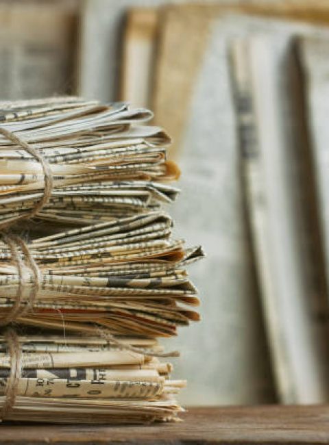 Waste paper pile in vintage style. Old newspaper abstract background. Paper trash waste paper.